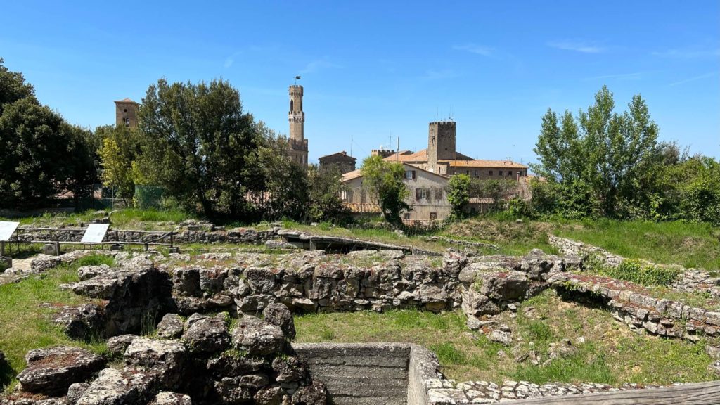 ruins of an etruscan acropolis with volterra, italy skylinein the background