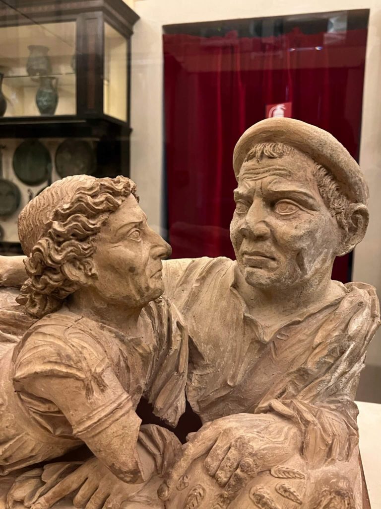funerary urn with a couple looking at each other in volterra, italy