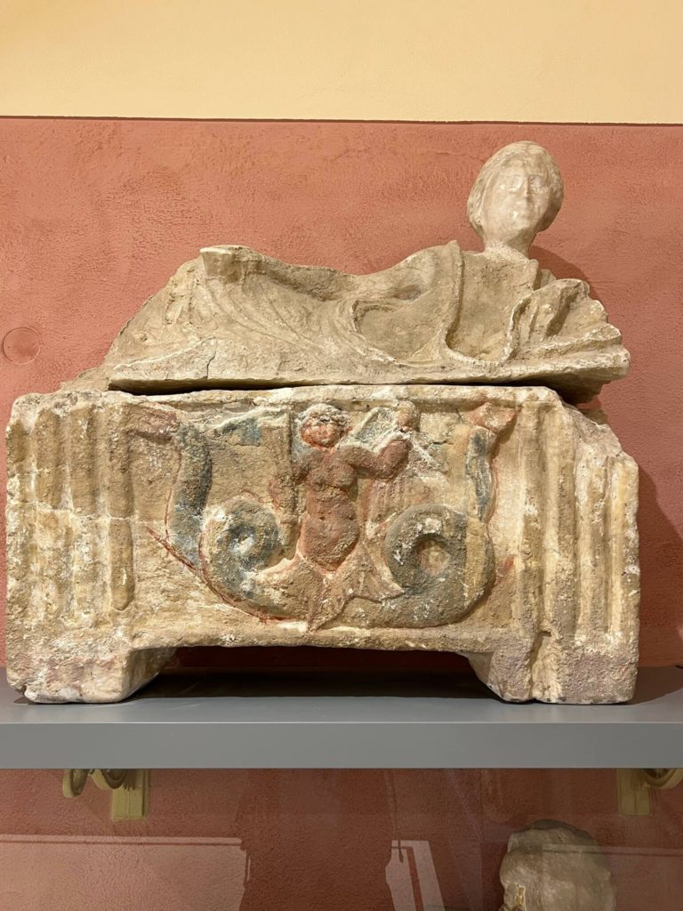 funerary urn with pigment still on it in etruscan museum