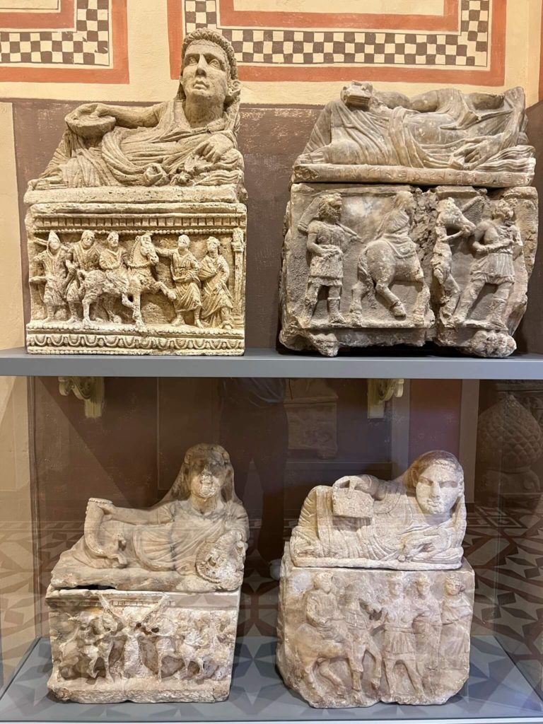 etruscan funerary urns in volterra's etruscan museum