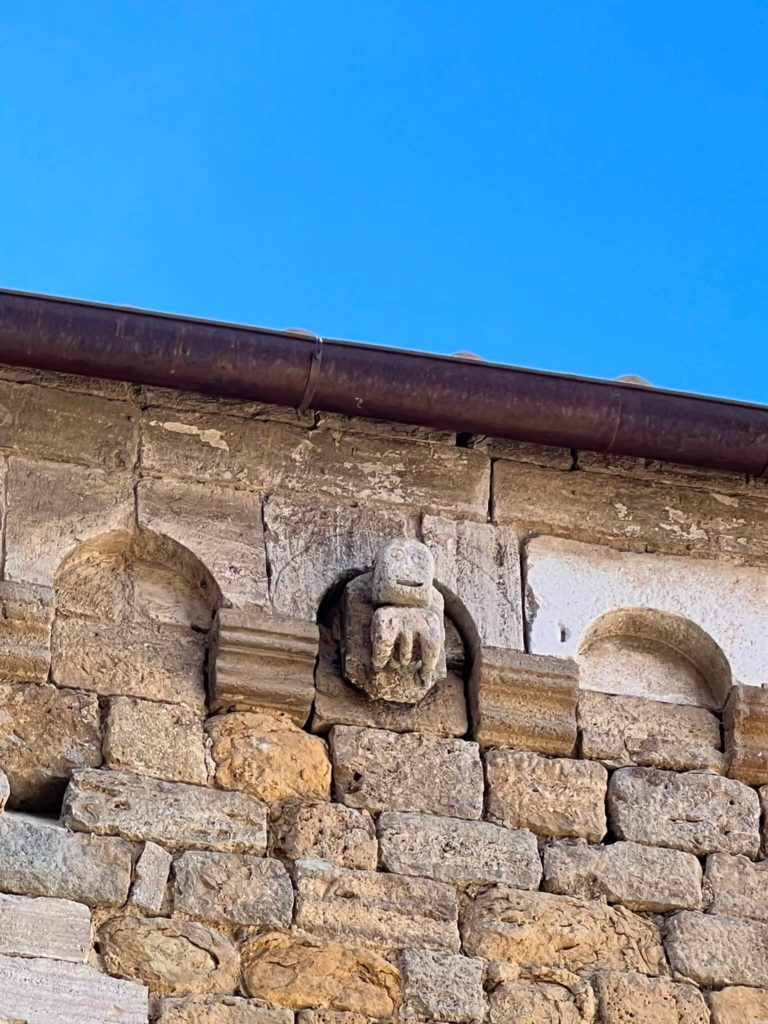 a relief of an octopus on the side of a building in volterra, italy