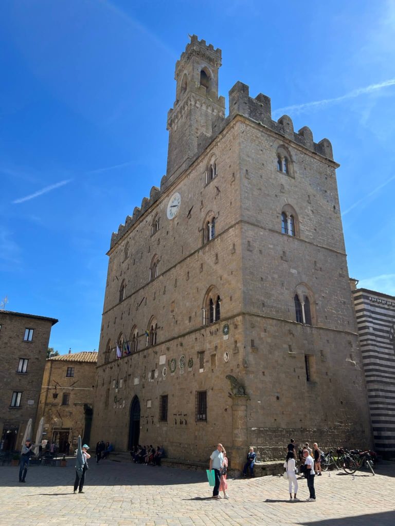 volterra's city hall with a single tower rising into the sky