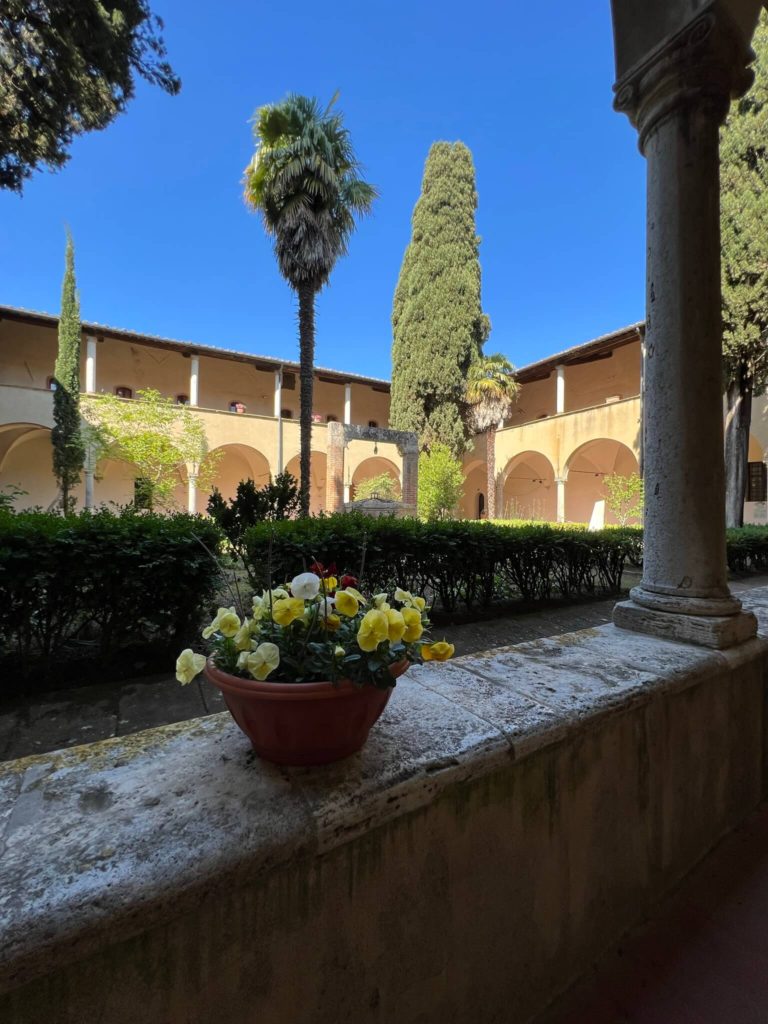 peaceful church cloister with flowers in the foreground
