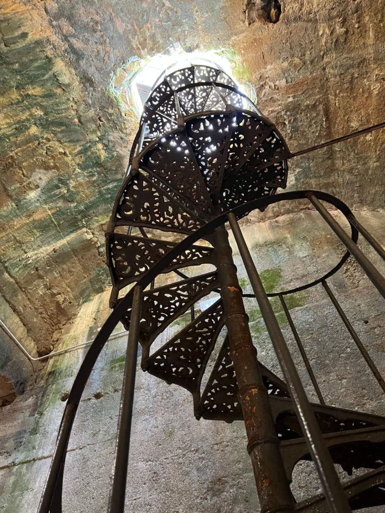 spiral staircase leading to volterra, italy's roman cistern