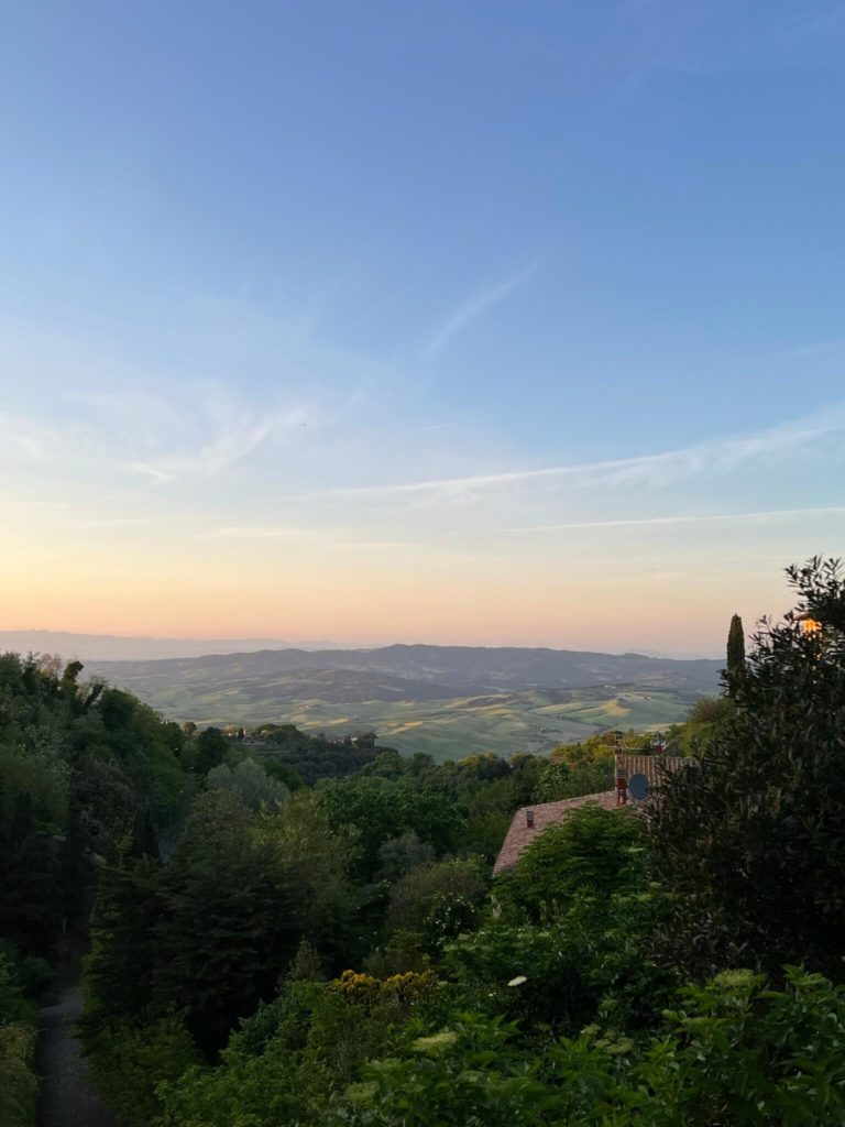 the sun setting over tuscany from volterra, italy