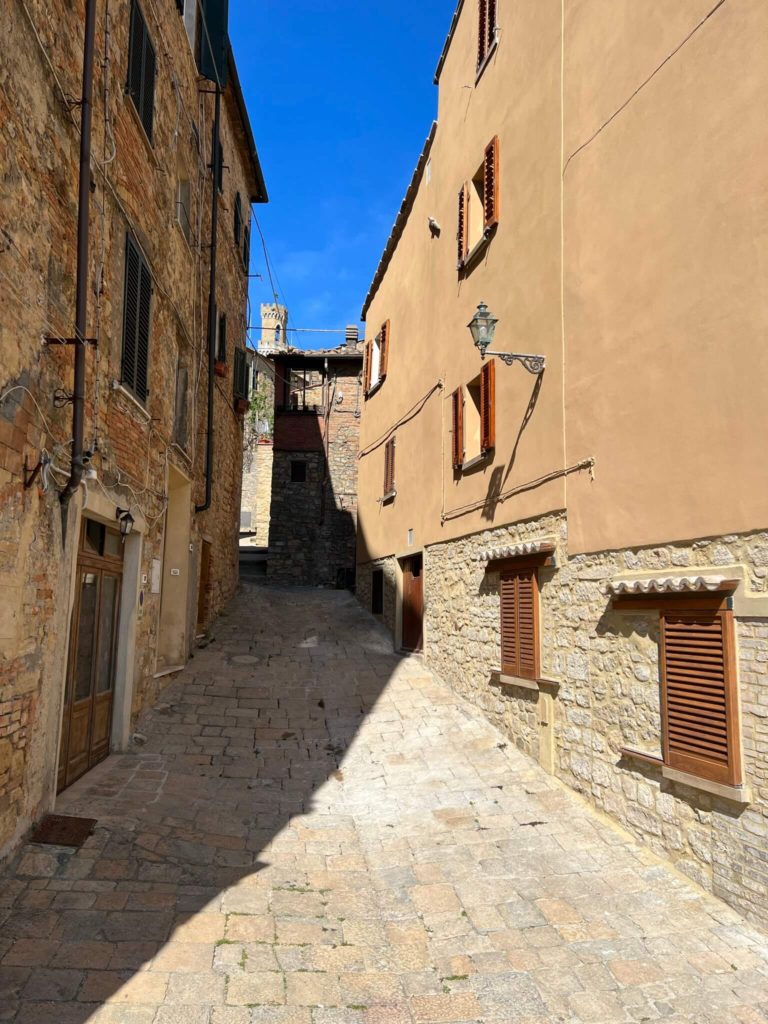 unadorned alleyway in volterra, italy