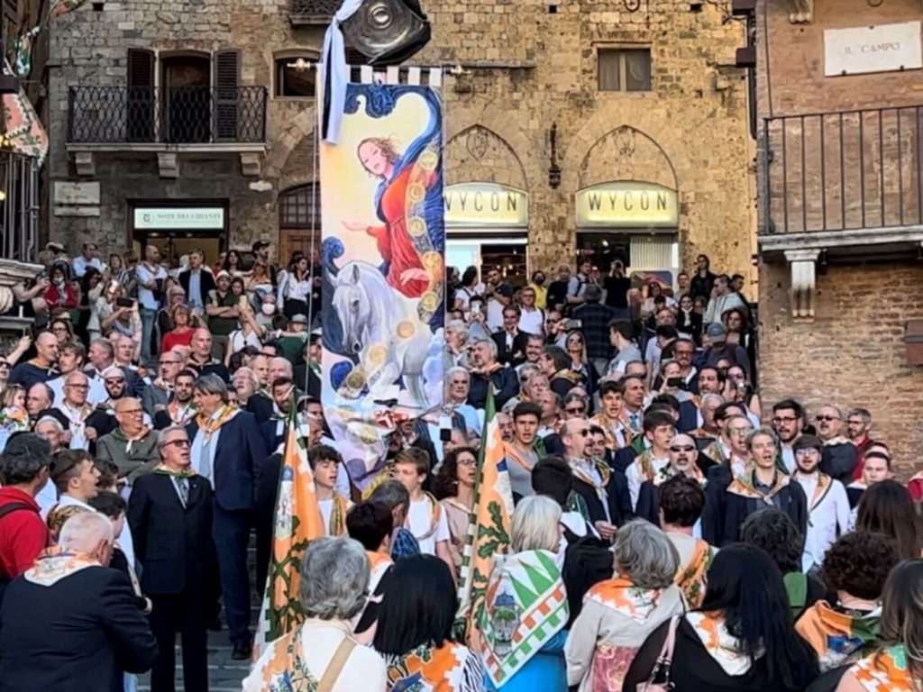 a group from a local contrada holding a parade