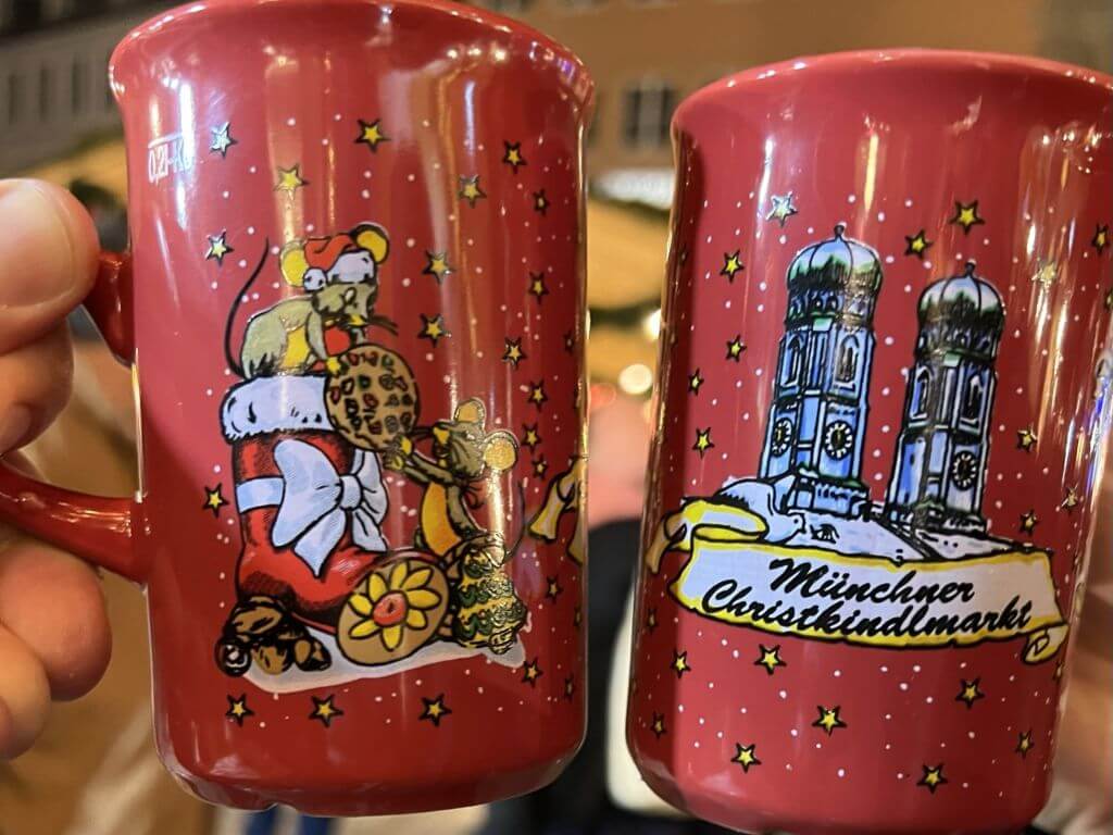 Two Red Decorated Mugs Of Gluhwein At Munich's Christmas Market