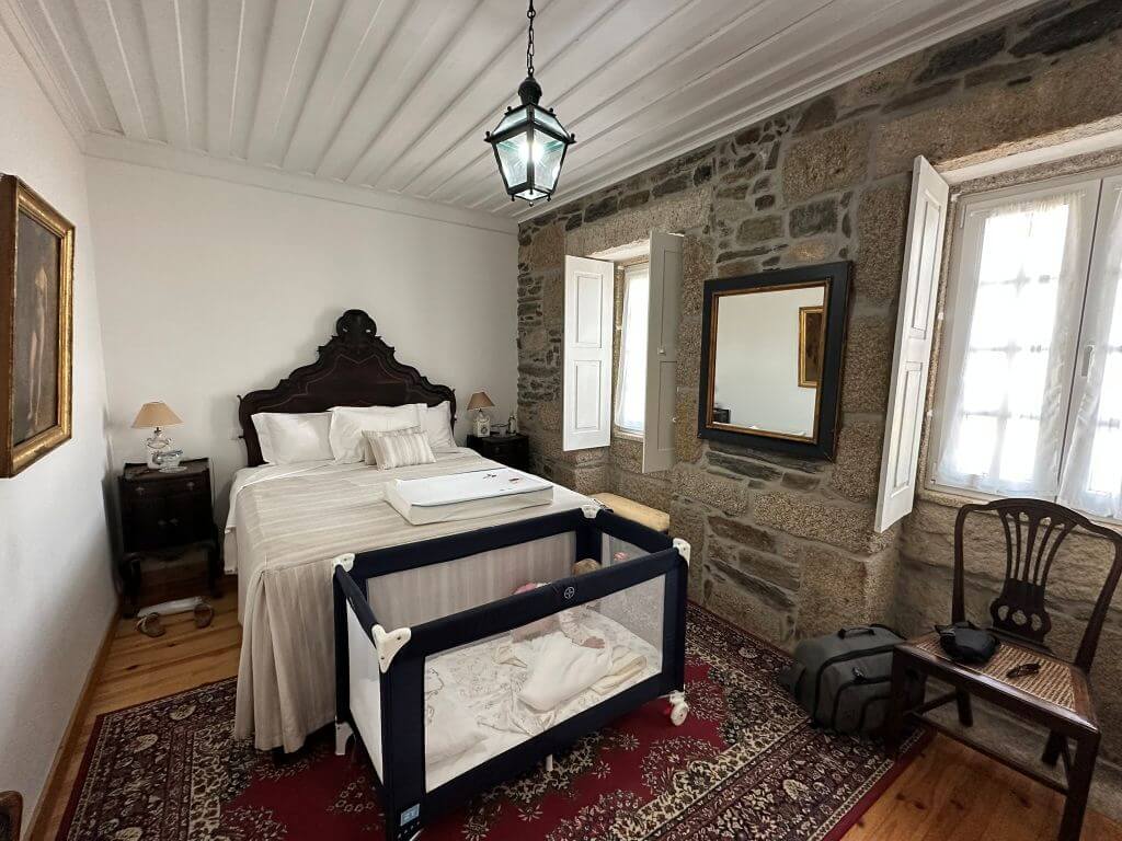 Bedroom With Antique Furniture And A Stone Wall At Quinta Do Valdalagea