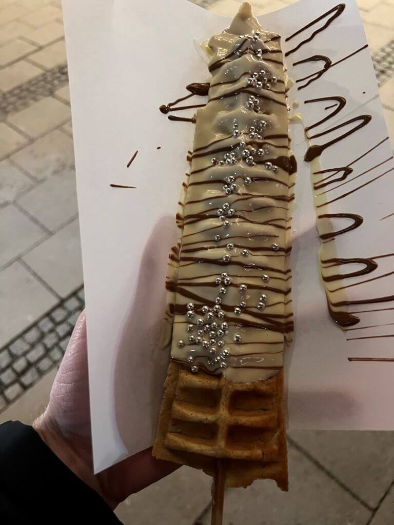 A Waffle Shaped Into A Christmas Tree And Covered In White And Chocolate Frosting At Munich's Christmas Market